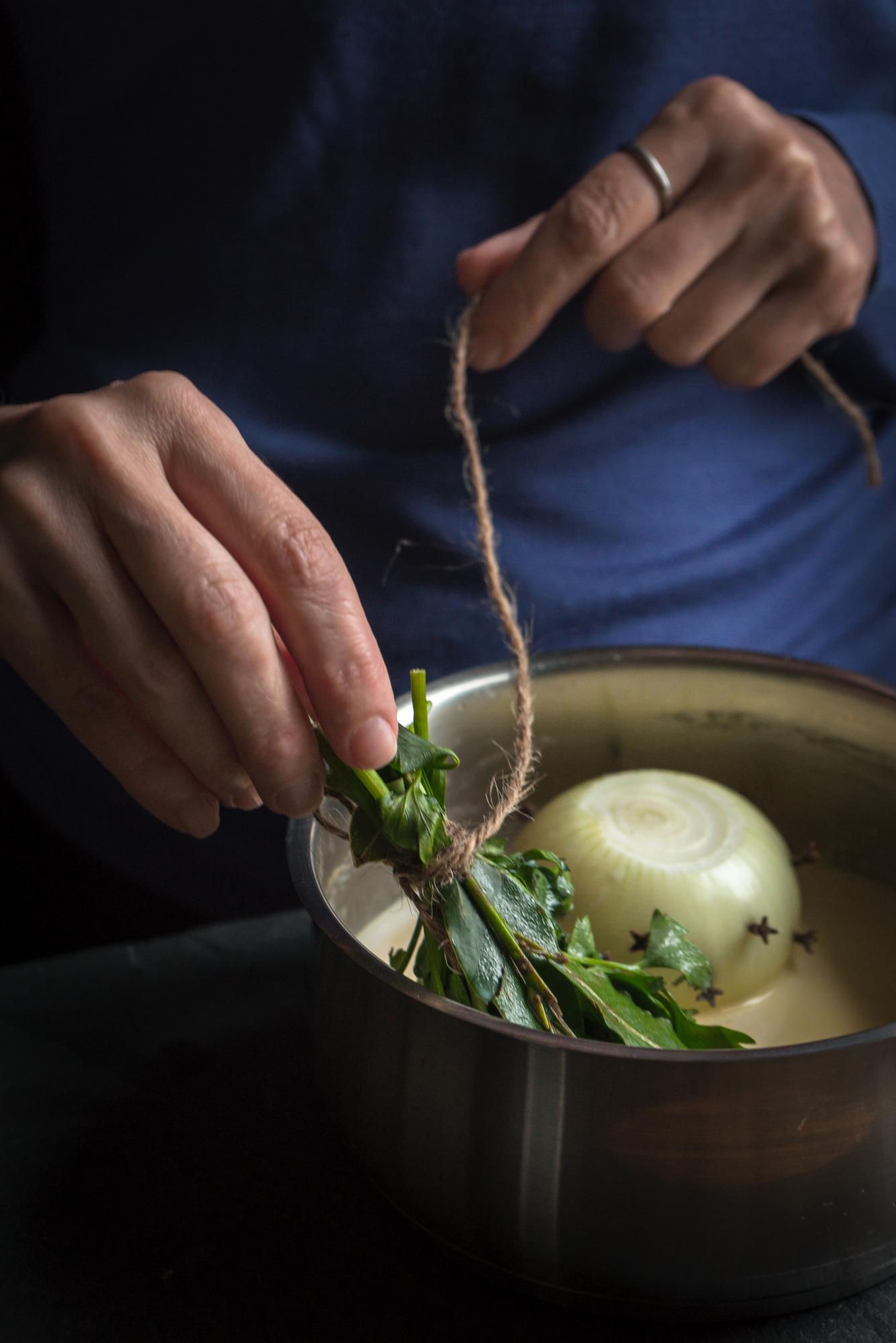 Chef arranging plated seasonal dish on wooden table